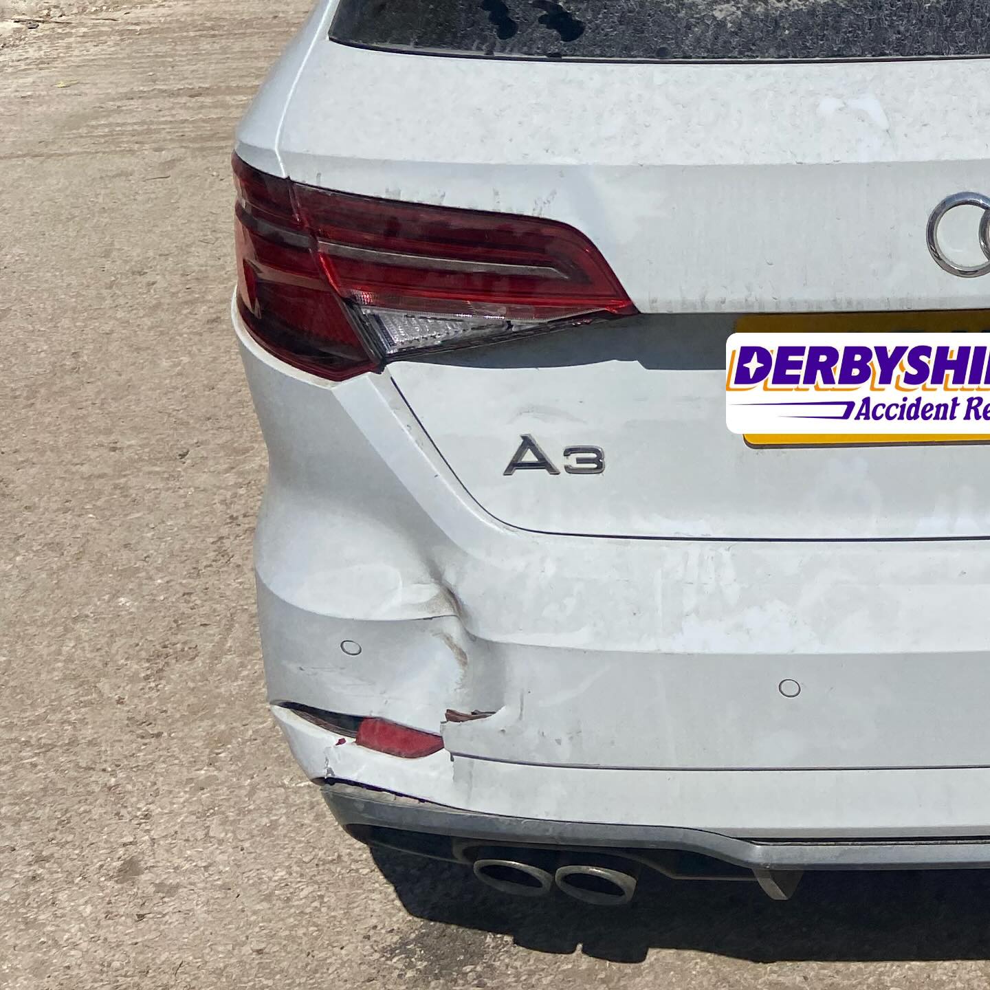 Audi A3 rear bumper corner and tailgate before repair, showing a cracked and creased bumper