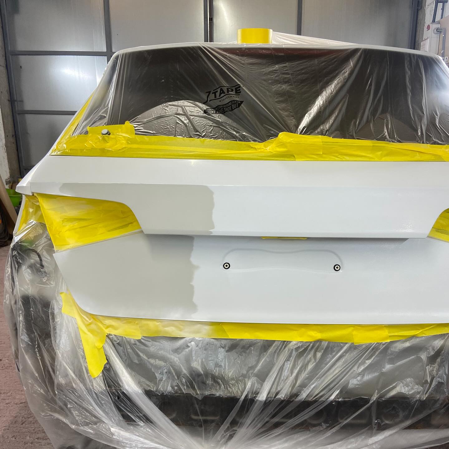 Audi tailgate masked up and part-sprayed during colour matching