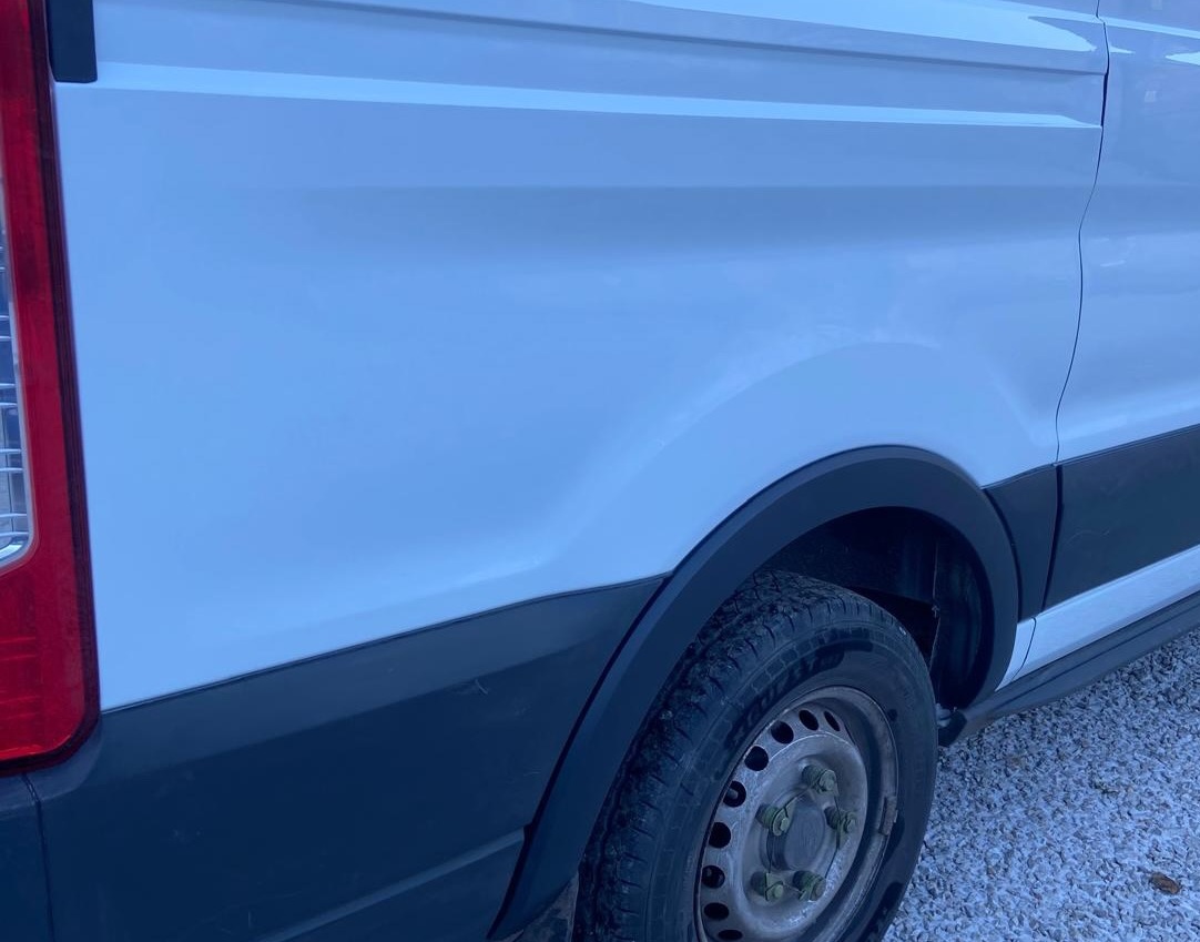 The same wheel arch and bodywork after repair, refinished and ready for collection
